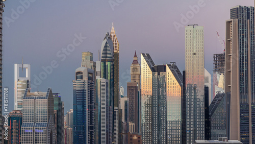 Aerial view of new skyscrapers and tall buildings in Dubai day to night timelapse