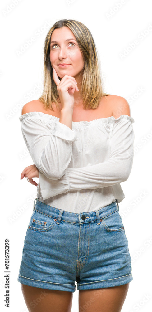 Young beautiful woman over isolated background with hand on chin thinking about question, pensive expression. Smiling with thoughtful face. Doubt concept. Young beautiful woman over isolated background with hand on chin thinking about question, pensive expression. Smiling with thoughtful face. Doubt concept.