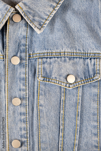 Denim jacket collar and pocket, texture background.