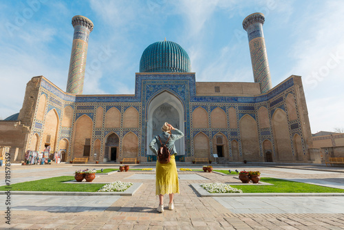 happy tourist with hat looking Gur-E Amir Mausoleum, the tomb of the Asian conqueror Tamerlane or Timur, in Samarkand, Uzbekistan