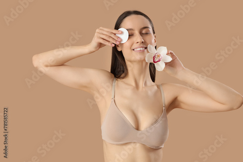 Young woman with cotton pad...