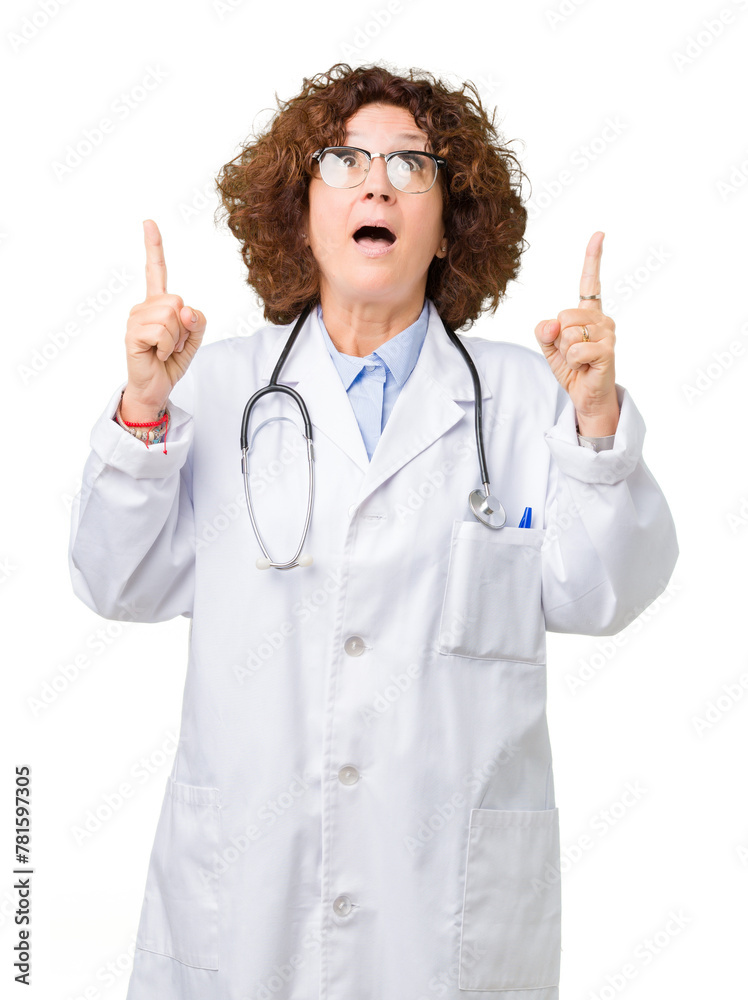 Middle ager senior doctor woman over isolated background amazed and surprised looking up and pointing with fingers and raised arms. Middle ager senior doctor woman over isolated background amazed and surprised looking up and pointing with fingers and raised arms.