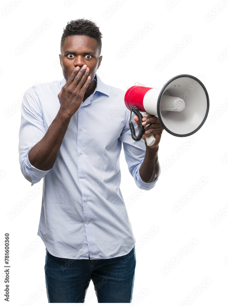 Young african american man holding megaphone cover mouth with hand shocked with shame for mistake, expression of fear, scared in silence, secret concept Young african american man holding megaphone cover mouth with hand shocked with shame for mistake, expression of fear, scared in silence, secret concept
