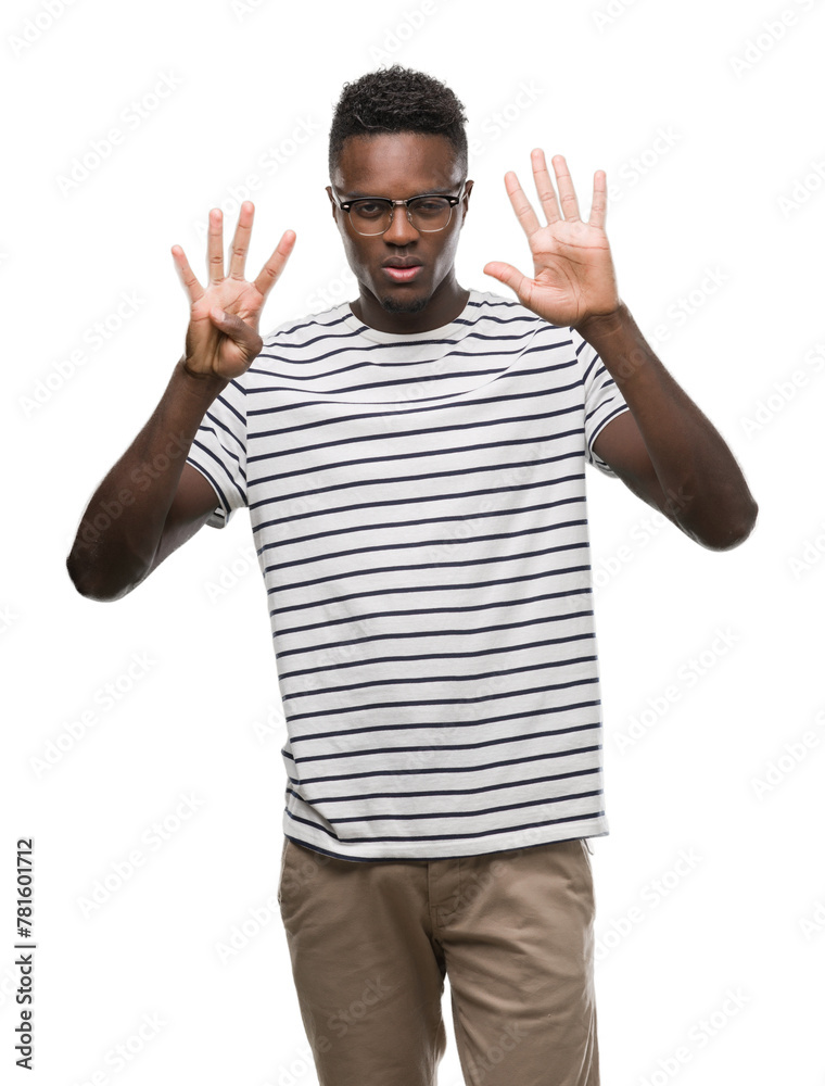 Young african american man wearing glasses and navy t-shirt showing and pointing up with fingers number nine while smiling confident and happy. Young african american man wearing glasses and navy t-shirt showing and pointing up with fingers number nine while smiling confident and happy.