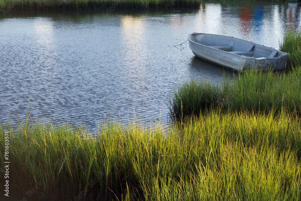 boat on the water with tidal grasses boat on the water with tidal grasses