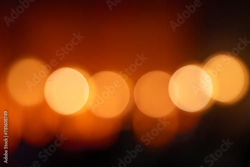Golden blurred bokeh lights on black background.