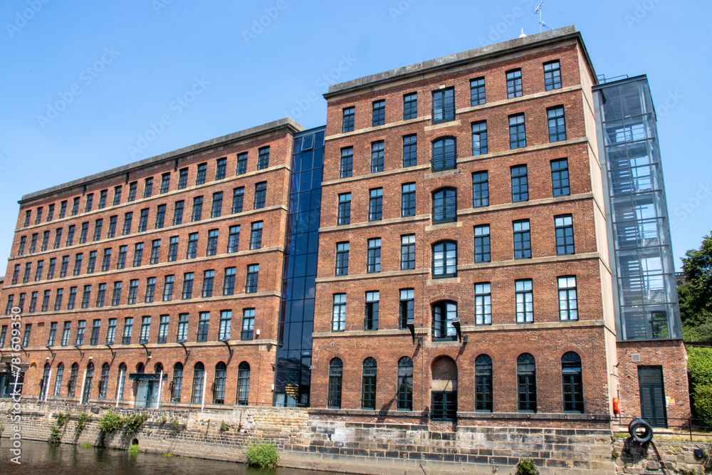 A converted mill by the canal in the city of Leeds on a hot sunny summers day