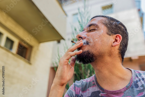 A Joint In Hand A Man Smokes Cannabis Weed. Concepts Of Medical Marijuana Use And Legalization Of The Cannabis.