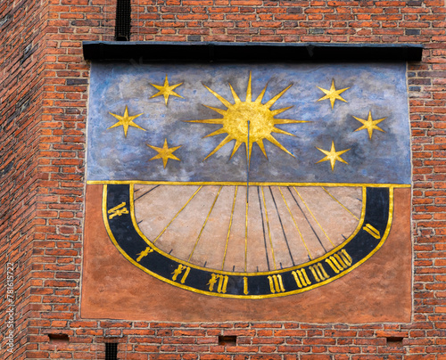 Ancient outdoor sundial on the brick wall	