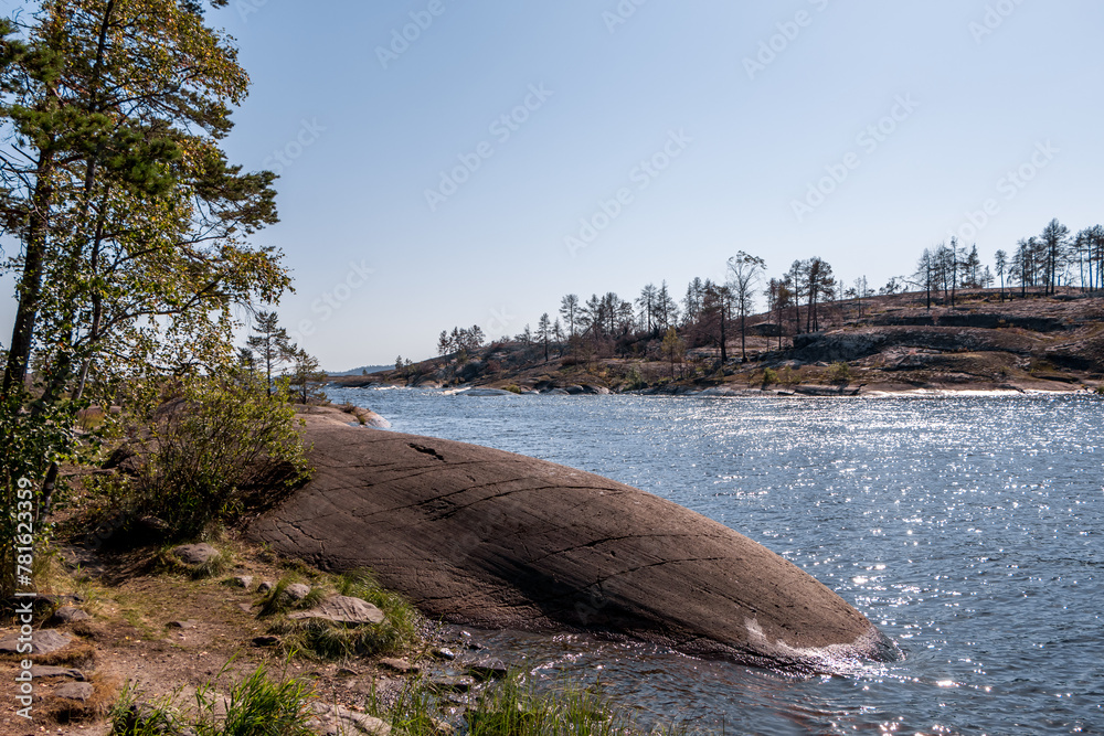 Lake Ladoga and rocky islands. Karelian forest, trees growing on rocks. Ladoga skerries. Nordic Scandinavian landscape Lake Ladoga and rocky islands. Karelian forest, trees growing on rocks. Ladoga skerries. Nordic Scandinavian landscape