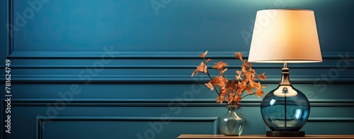 close up of a lamp in modern interior, blue wall with moulding in background photo