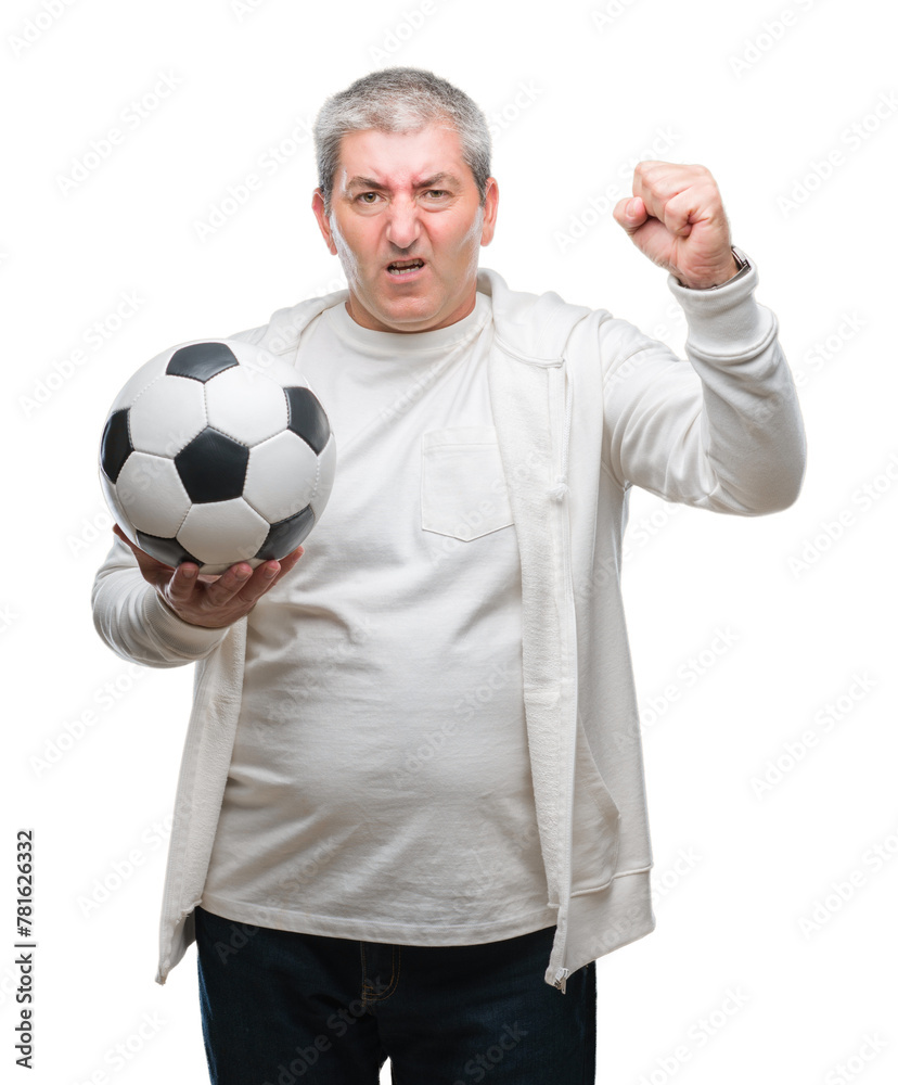 Handsome senior man holding soccer football ball over isolated background annoyed and frustrated shouting with anger, crazy and yelling with raised hand, anger concept