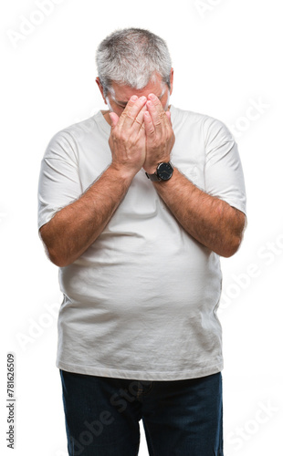 Handsome senior man over isolated background with sad expression covering face with hands while crying. Depression concept.