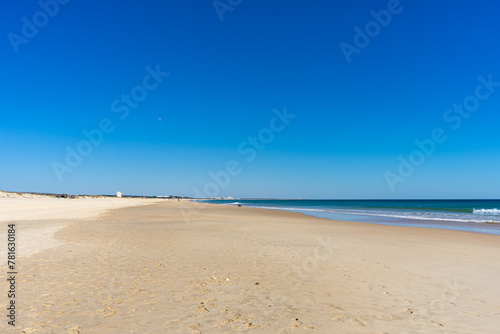 View of idyllic nature landscape with huge beaches and waves crashing on. Manta Rota beach. West Atlantic coast of Algarve region, south of Portugal.