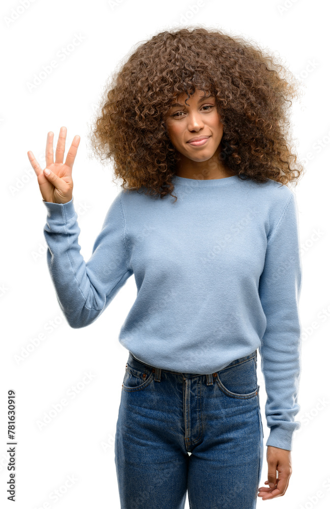 African american woman wearing a sweater showing and pointing up with fingers number four while smiling confident and happy. African american woman wearing a sweater showing and pointing up with fingers number four while smiling confident and happy.