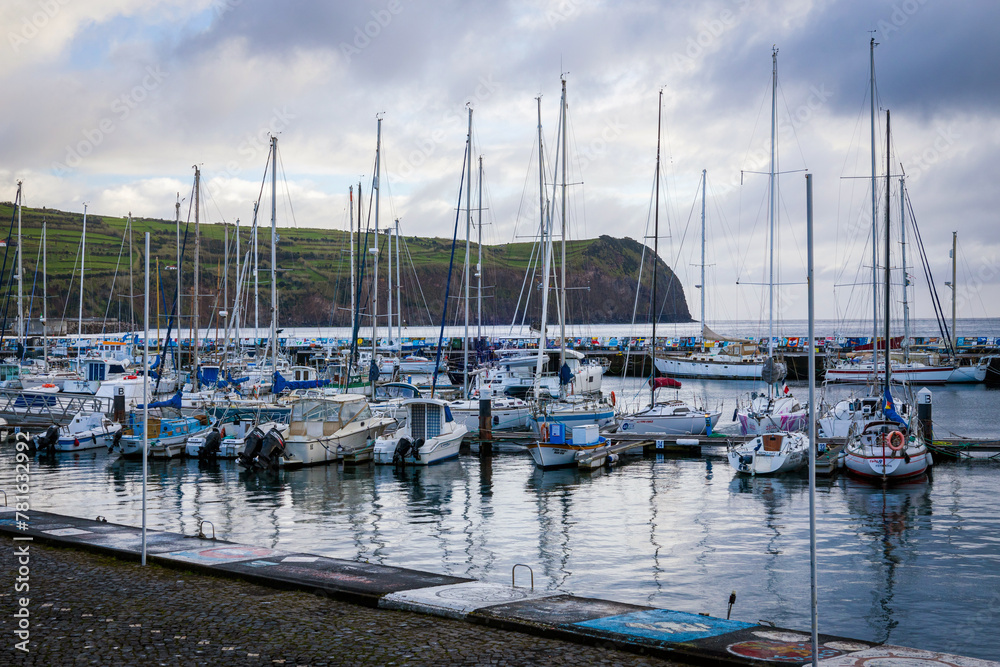 Marina in Horta, Faial island, Azores, Portugal. Moored yachts and boats along the port piers.