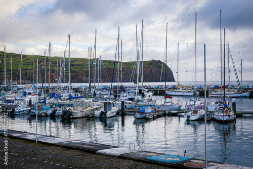 Marina in Horta, Faial island, Azores, Portugal. Moored yachts and boats along the port piers.