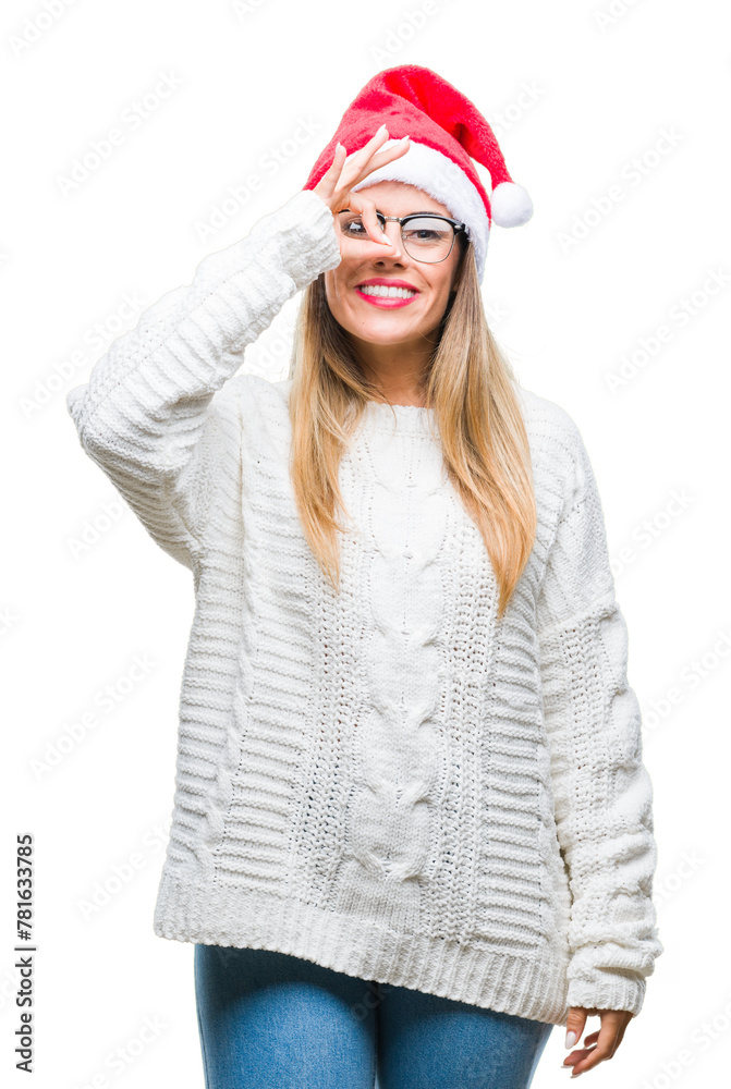 Young beautiful woman wearing christmas hat over isolated background doing ok gesture with hand smiling, eye looking through fingers with happy face. Young beautiful woman wearing christmas hat over isolated background doing ok gesture with hand smiling, eye looking through fingers with happy face.
