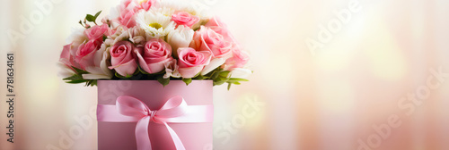 Bouquet of beautiful roses in gift box on blurred background, closeup. Happy Mother's Day or Happy Women's day, birthday card or banner.