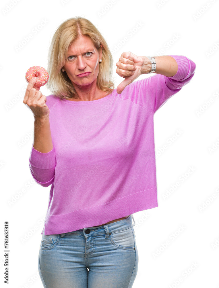Middle age blonde woman eating pink donut over isolated background with angry face, negative sign showing dislike with thumbs down, rejection concept Middle age blonde woman eating pink donut over isolated background with angry face, negative sign showing dislike with thumbs down, rejection concept