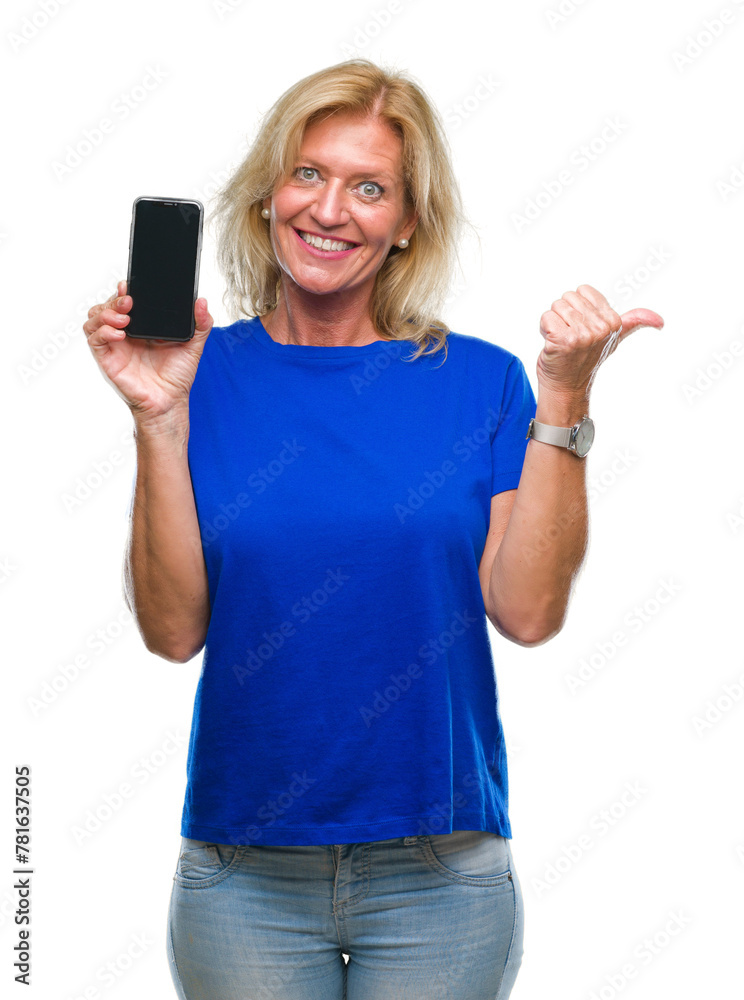 Middle age blonde woman showing blank screen of smartphone over isolated background pointing and showing with thumb up to the side with happy face smiling Middle age blonde woman showing blank screen of smartphone over isolated background pointing and showing with thumb up to the side with happy face smiling
