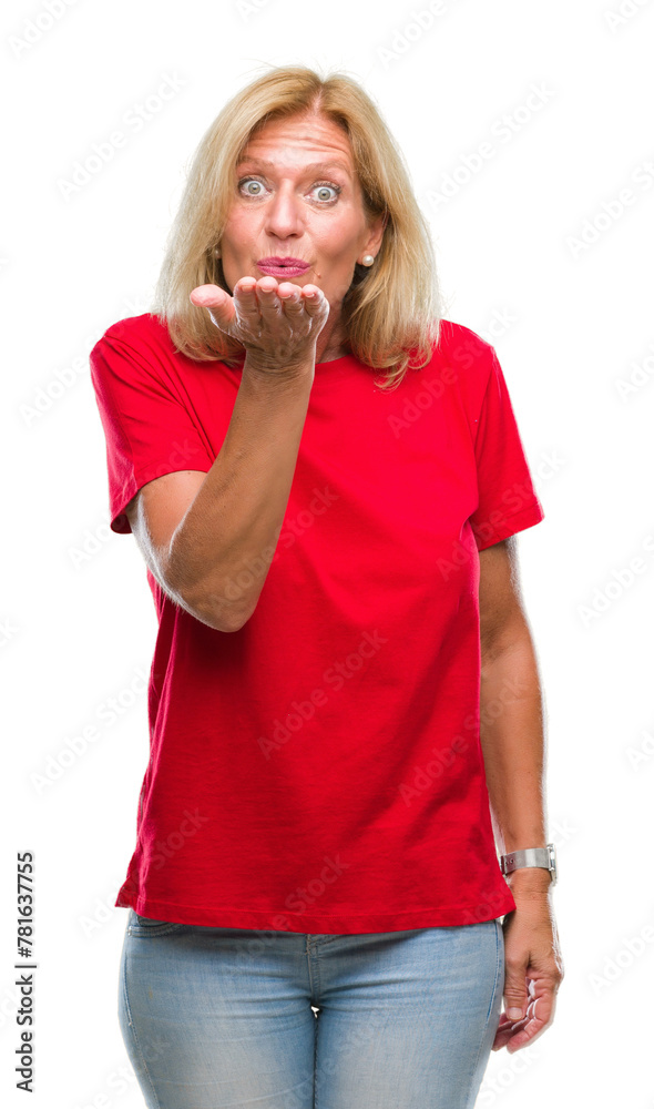 Middle age blonde woman over isolated background looking at the camera blowing a kiss with hand on air being lovely and sexy. Love expression. Middle age blonde woman over isolated background looking at the camera blowing a kiss with hand on air being lovely and sexy. Love expression.