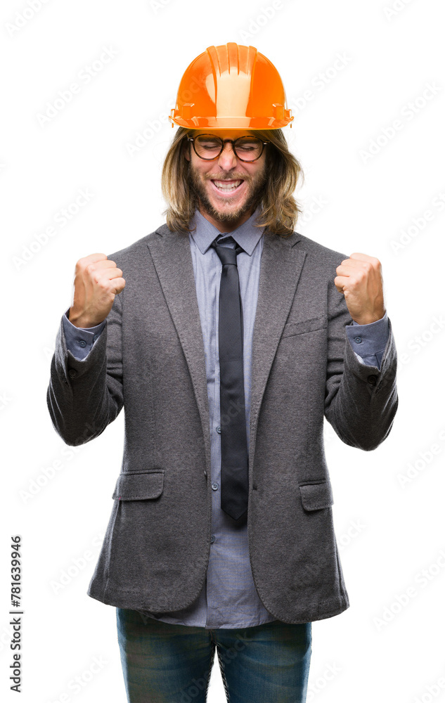 Young handsome architec man with long hair wearing safety helmet over isolated background very happy and excited doing winner gesture with arms raised, smiling and screaming for success Young handsome architec man with long hair wearing safety helmet over isolated background very happy and excited doing winner gesture with arms raised, smiling and screaming for success