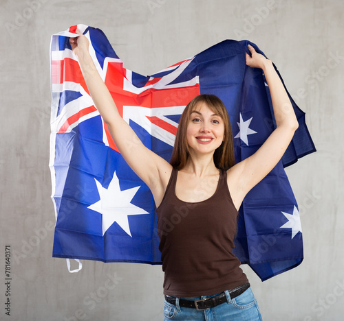 Young pretty woman posing cheerfully with flag of australia photo