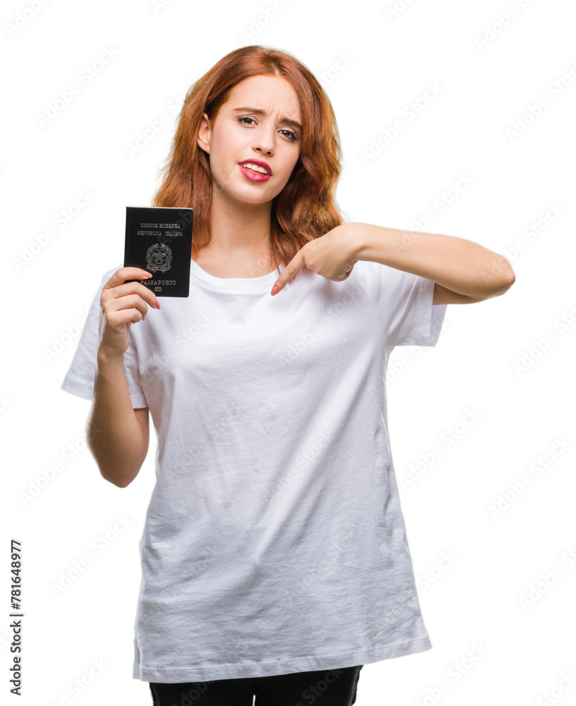 Young beautiful woman holding passport of italy over isolated background with surprise face pointing finger to himself