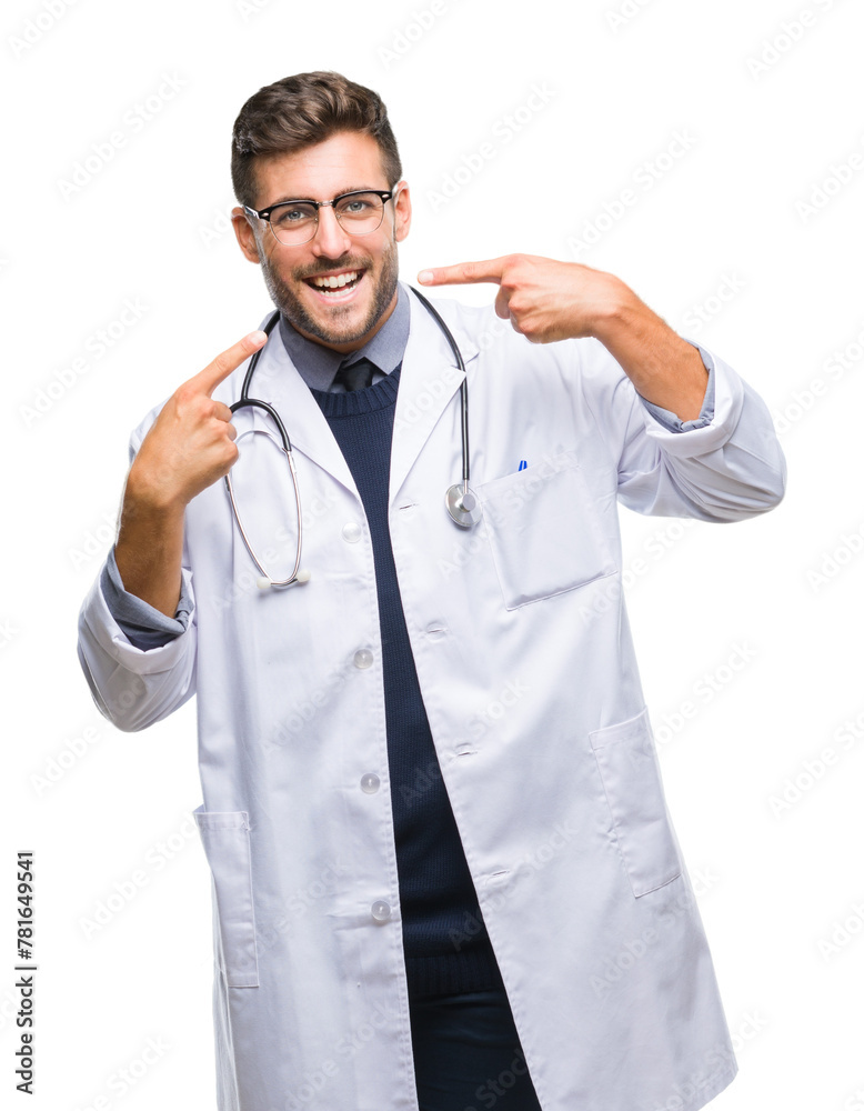 Young handsome doctor man over isolated background smiling confident showing and pointing with fingers teeth and mouth. Health concept. Young handsome doctor man over isolated background smiling confident showing and pointing with fingers teeth and mouth. Health concept.