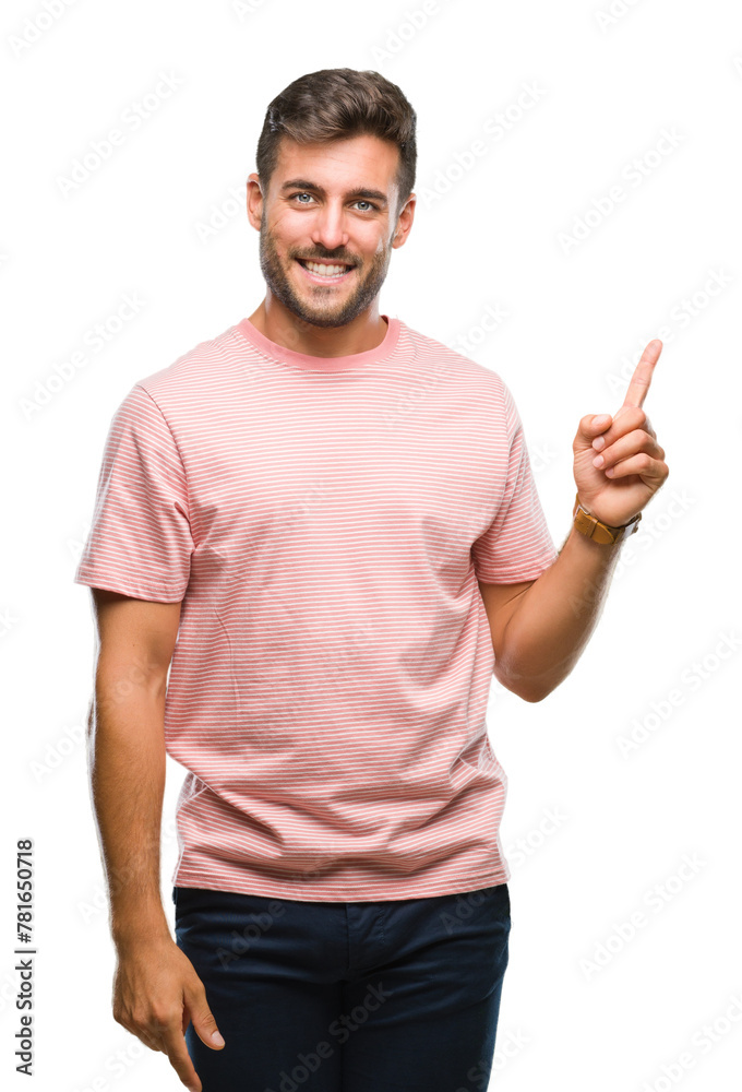 Young handsome man over isolated background with a big smile on face, pointing with hand and finger to the side looking at the camera. Young handsome man over isolated background with a big smile on face, pointing with hand and finger to the side looking at the camera.
