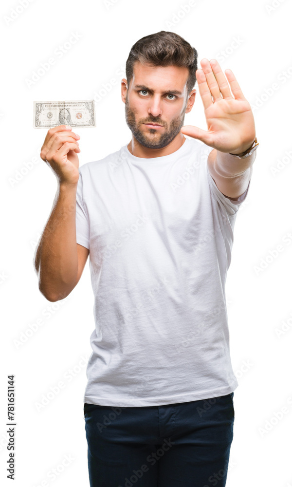 Young handsome man holding dollars over isolated background with open hand doing stop sign with serious and confident expression, defense gesture Young handsome man holding dollars over isolated background with open hand doing stop sign with serious and confident expression, defense gesture