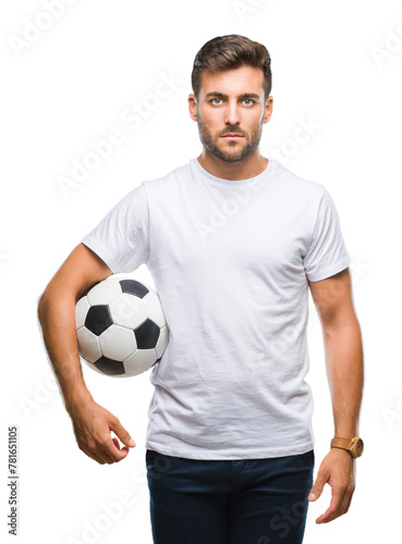 Young handsome man holding soccer football ball over isolated background with a confident expression on smart face thinking serious