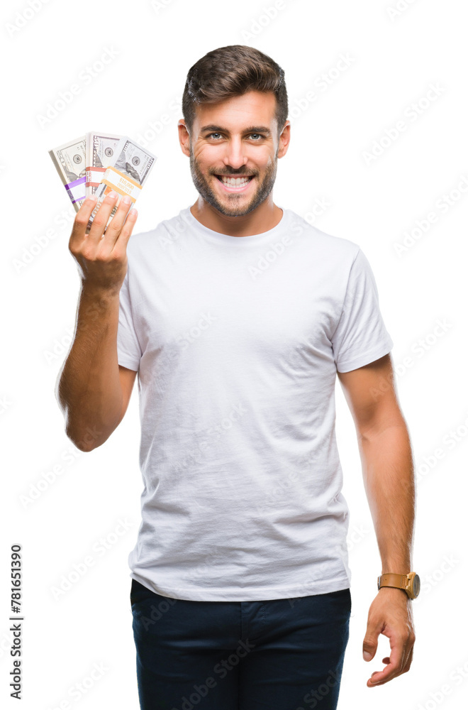 Young handsome man holding stack of dollars over isolated background with a happy face standing and smiling with a confident smile showing teeth Young handsome man holding stack of dollars over isolated background with a happy face standing and smiling with a confident smile showing teeth