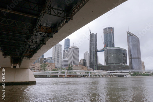 Brisbane river with bridge & city skyline buildings .