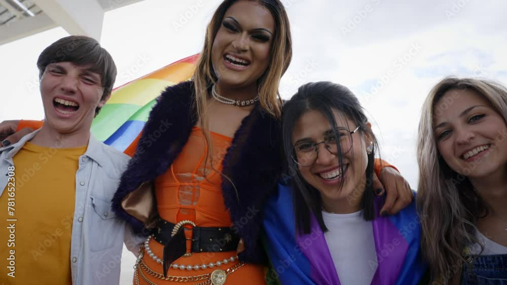 Low angle. A group of diverse happy young people are posing looking ...