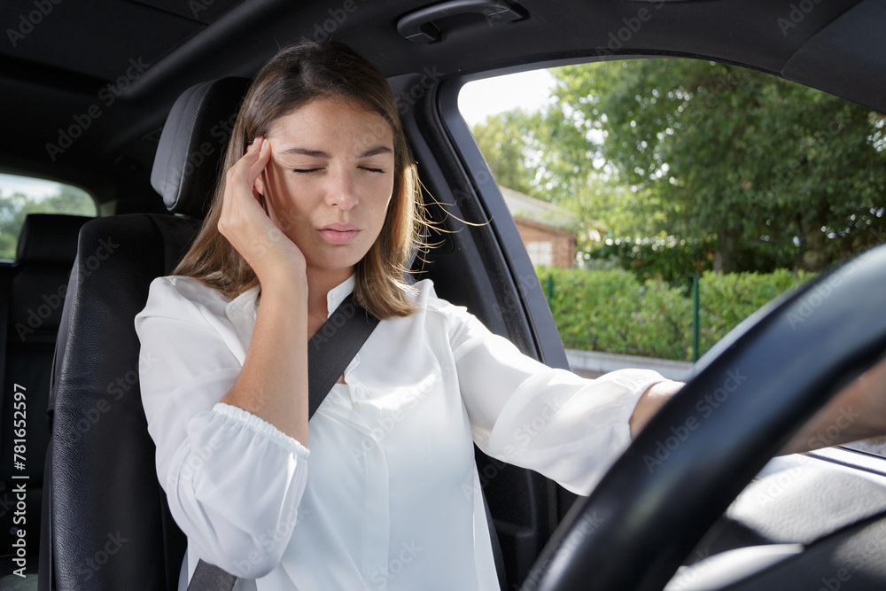 woman with headache in a car