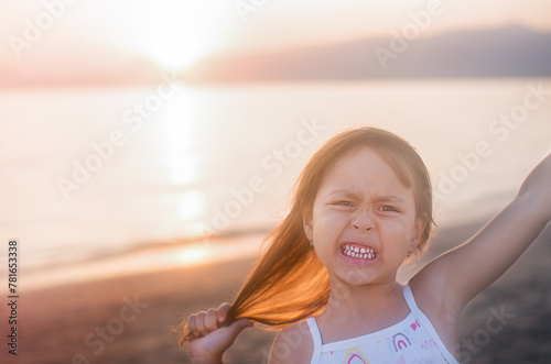 Girl at sunset against the background of the sea