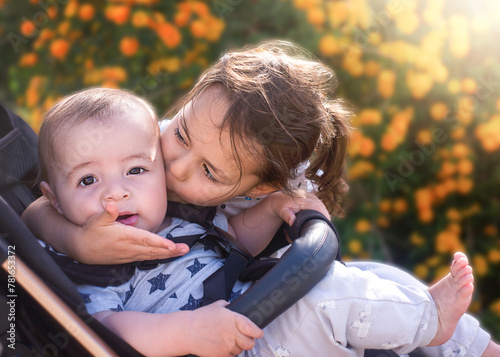 Big sister kisses little brother