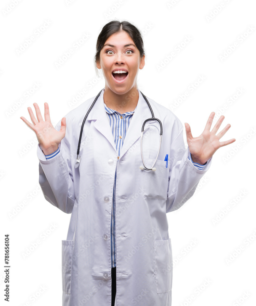 Young hispanic doctor woman very happy and excited, winner expression celebrating victory screaming with big smile and raised hands Young hispanic doctor woman very happy and excited, winner expression celebrating victory screaming with big smile and raised hands