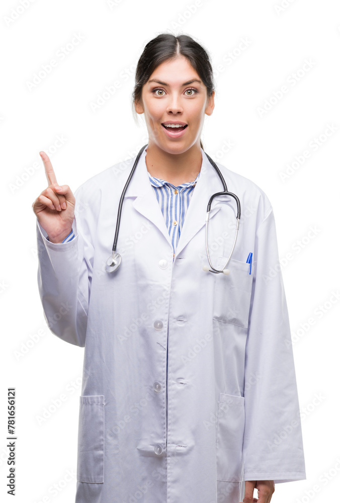 Young hispanic doctor woman surprised with an idea or question pointing finger with happy face, number one Young hispanic doctor woman surprised with an idea or question pointing finger with happy face, number one