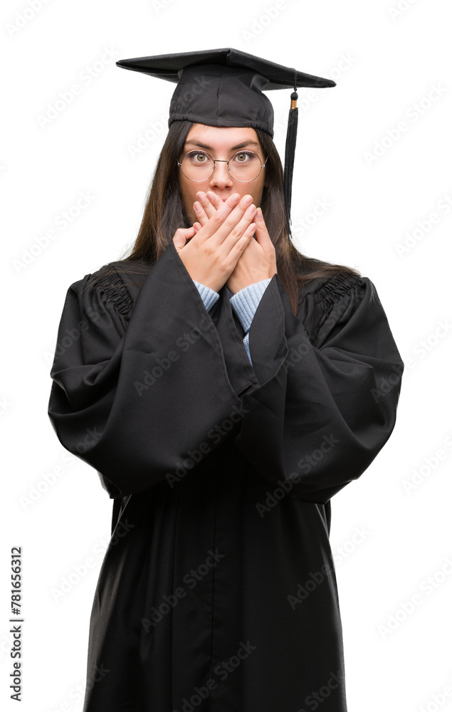 Young hispanic woman wearing graduated cap and uniform shocked covering mouth with hands for mistake. Secret concept. Young hispanic woman wearing graduated cap and uniform shocked covering mouth with hands for mistake. Secret concept.