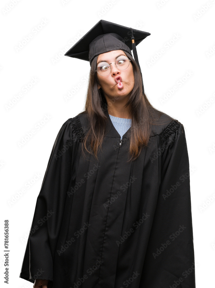 Young hispanic woman wearing graduated cap and uniform making fish face with lips, crazy and comical gesture. Funny expression. Young hispanic woman wearing graduated cap and uniform making fish face with lips, crazy and comical gesture. Funny expression.