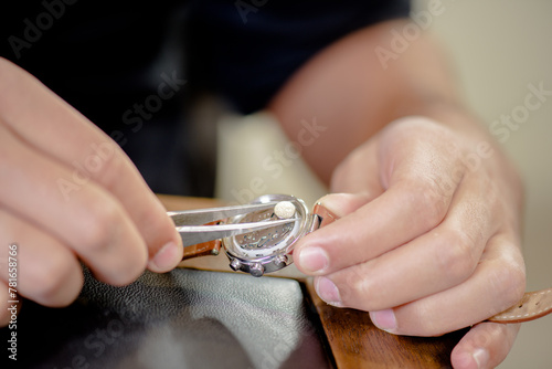 a close up of hands of watch maker