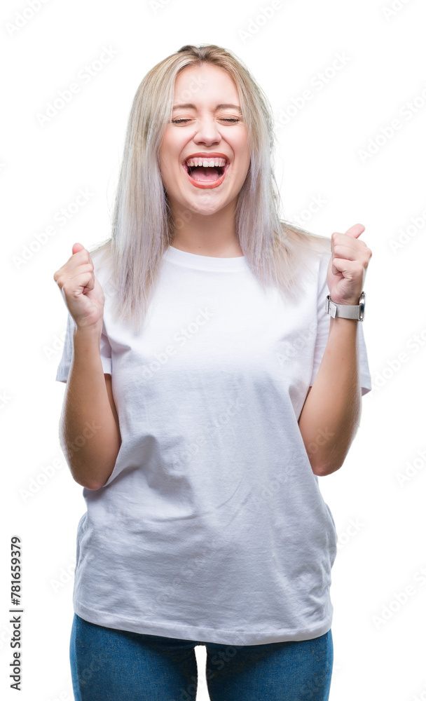 Young blonde woman over isolated background excited for success with arms raised celebrating victory smiling. Winner concept. Young blonde woman over isolated background excited for success with arms raised celebrating victory smiling. Winner concept.