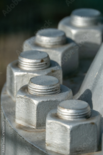 Close up of big nuts and bolts painted in silver