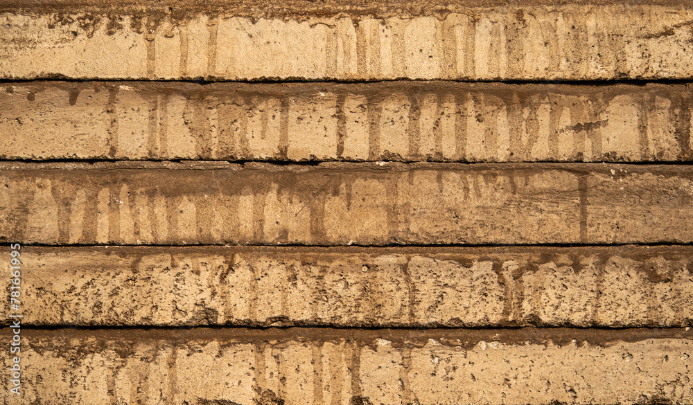 A cement surface with a brownish hue. The surface is covered in a layer of dirt and has a slightly worn appearance. The dirt appears to be a result of rain or other natural elements A cement surface with a brownish hue. The surface is covered in a layer of dirt and has a slightly worn appearance. The dirt appears to be a result of rain or other natural elements