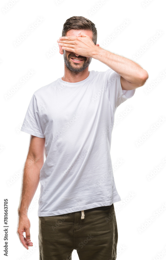 Fototapeta premium Young handsome man over isolated background smiling and laughing with hand on face covering eyes for surprise. Blind concept.