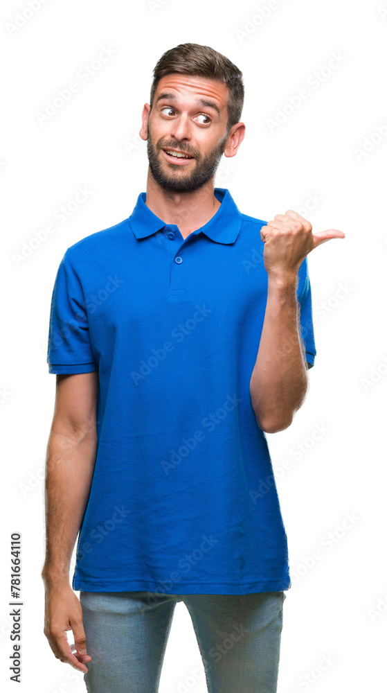 © Krakenimages.com - Young handsome man over isolated background smiling with happy face looking and pointing to the side with thumb up. © Krakenimages.com - Young handsome man over isolated background smiling with happy face looking and pointing to the side with thumb up.