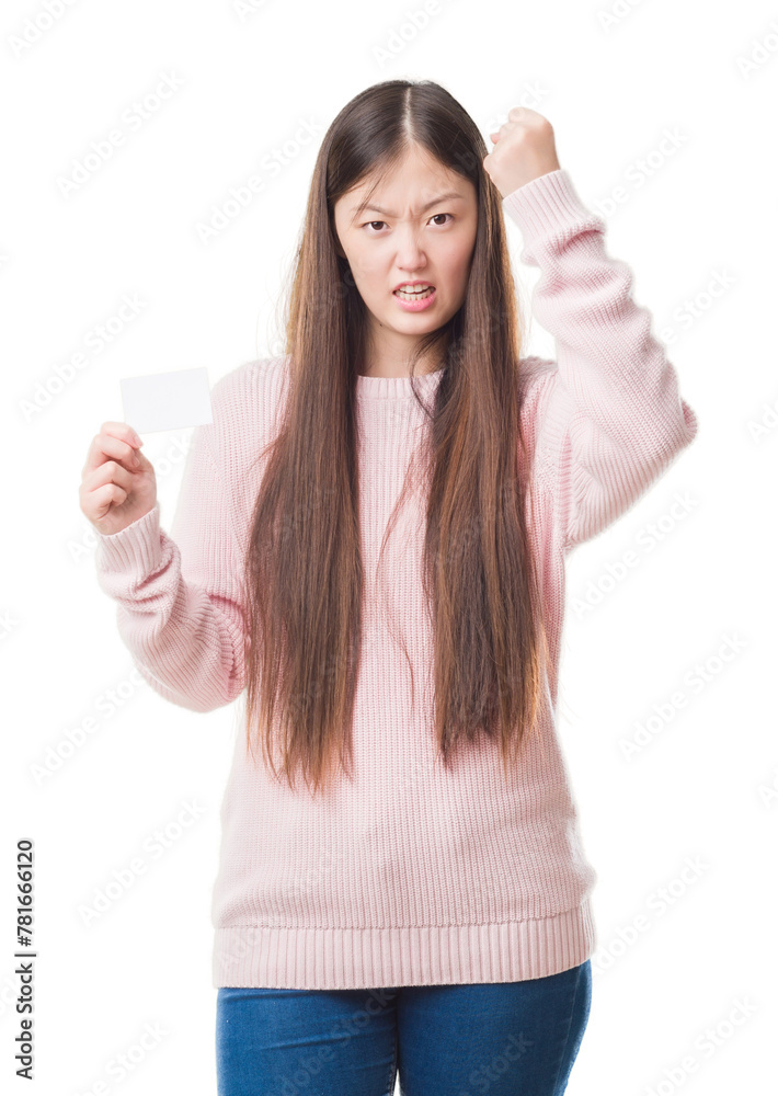 Young Chinese woman over isolated background holding visit card annoyed and frustrated shouting with anger, crazy and yelling with raised hand, anger concept Young Chinese woman over isolated background holding visit card annoyed and frustrated shouting with anger, crazy and yelling with raised hand, anger concept